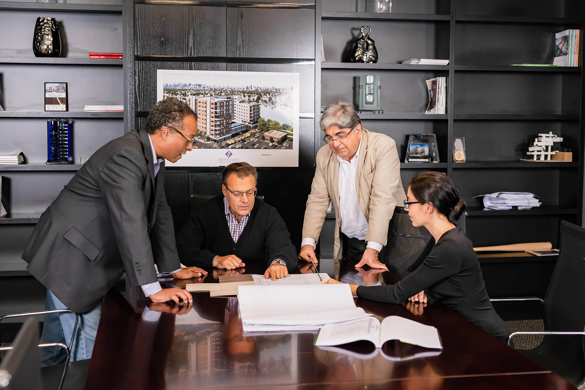 Netta Architects team reviewing architectural plans together in the studio.