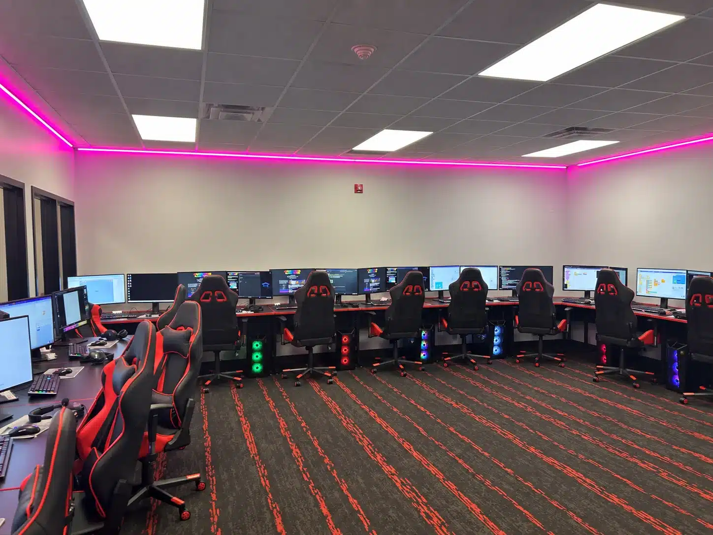 BCIT Medford video game design classroom with computer workstations and magenta perimeter lighting